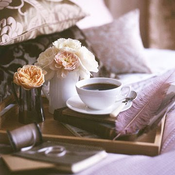 coffee and flowers in bed
