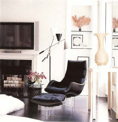 interiors in black and white modern living room in black and white furniture, lucite chairs and fireplace via belle vivir blog