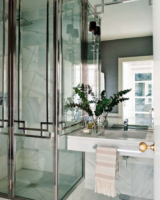 bathroom in black and white with marble sink and chrome shower doors via belle vivir blog