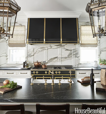 kitchen with black stoves, black stoves, White marble on the walls, pietra cardosa counter tops and black stove