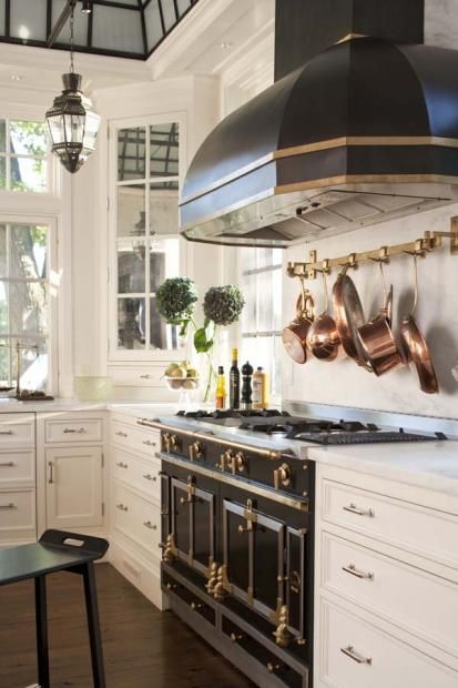 black la corneu stove with iron skyline on the ceiling and white cabinets