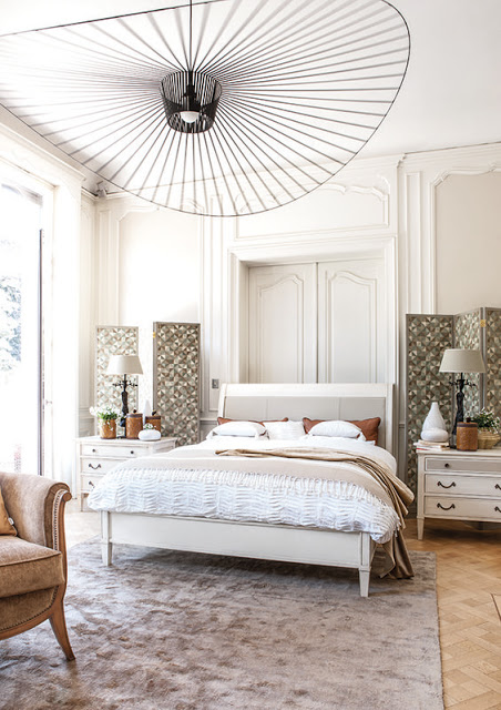 White bedroom with parquet floor and constance guisset light fixture