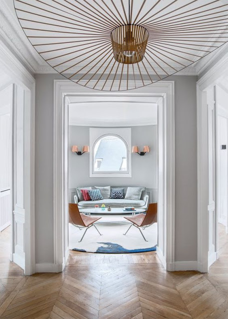 entry way with chevron floors, grey walls and vertigo pendant by constance guisset