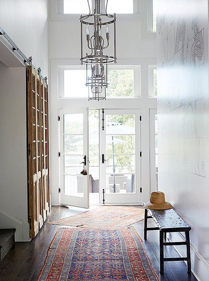 hallway with layered rug at an angle