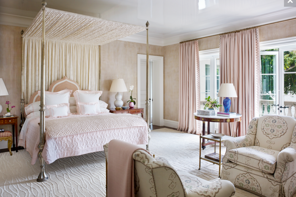 bedroom with canopy bed and pink curtains