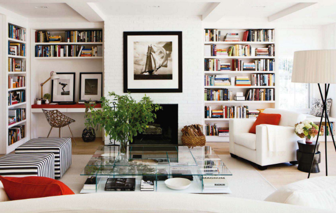 living room with bookcases and red pillows