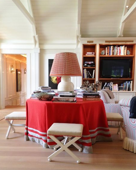 Red skirted table in Christopher Burch's home