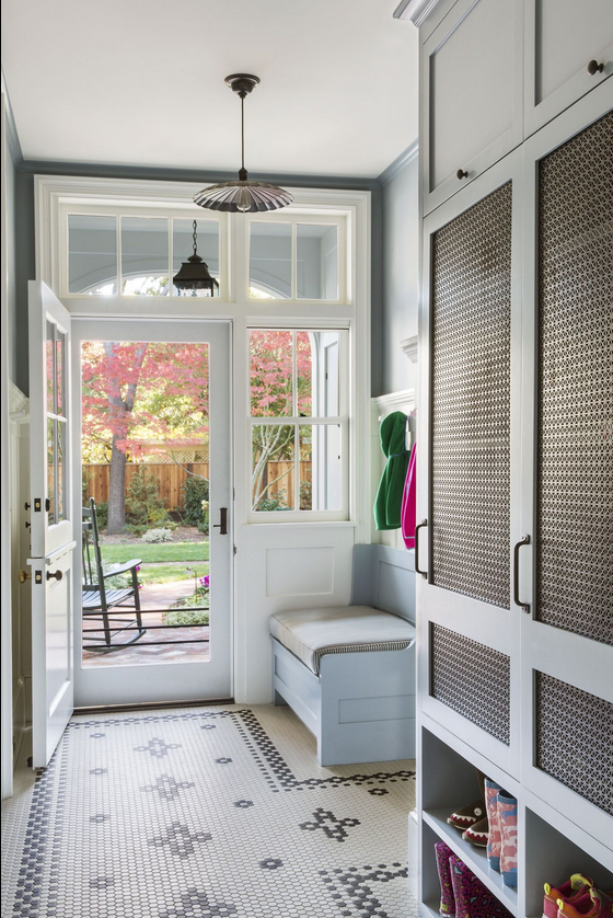 mudroom with bench and penny tiles