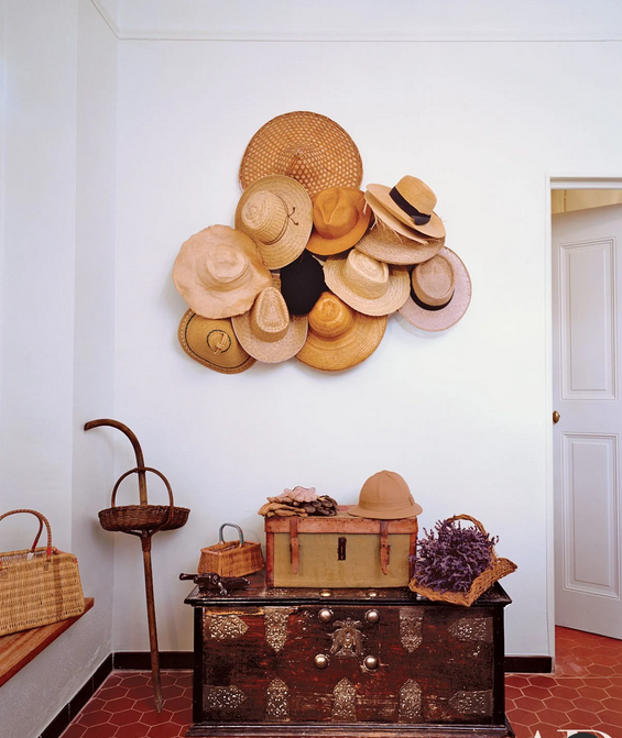 mudroom with hat art display